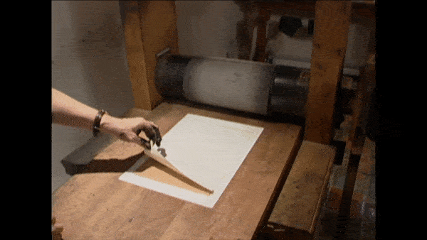 How Etchings Are Made: The press squeezes the paper and the plate together, impressing an inked image onto the paper.